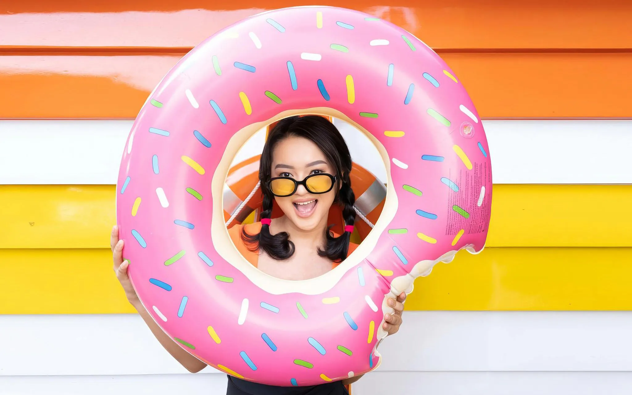 Young woman with donut float at Atlantis Water Adventure Park Ancol.
