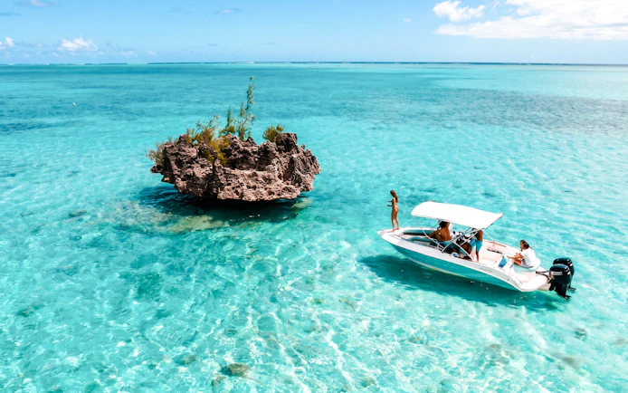 Speed boat near Crystal Rock in clear waters of Mauritius.