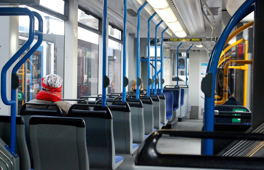 Passengers seated inside a tram in Amsterdam.