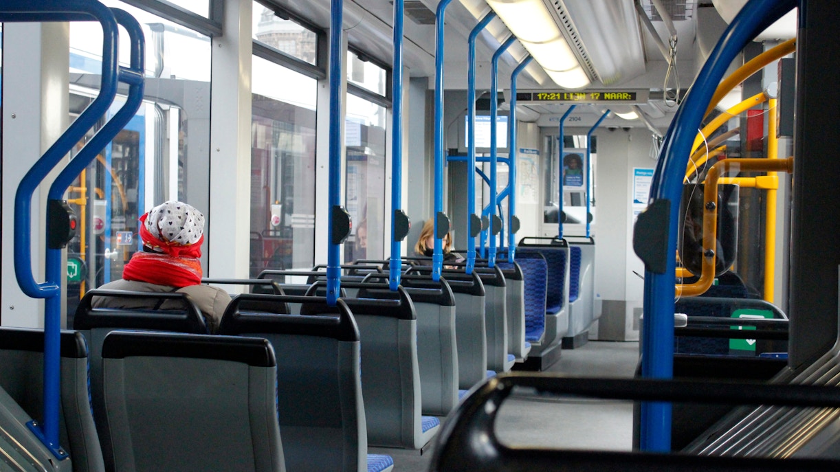 Passengers seated inside a tram in Amsterdam.