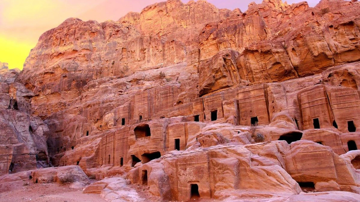 Ancient rock-cut architecture in Petra, Jordan at sunset.