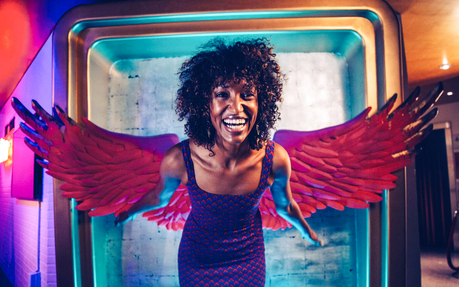 Guest posing with angel wings at Madame Tussauds Hollywood.