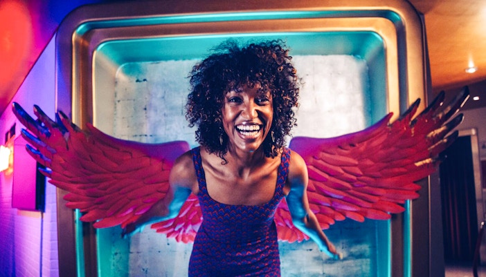 Guest posing with angel wings at Madame Tussauds Hollywood.