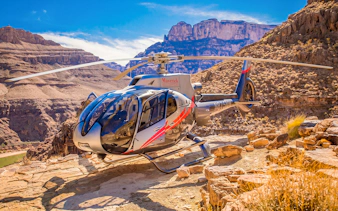 Helicopter landing at Grand Canyon West with canyon views in the background.
