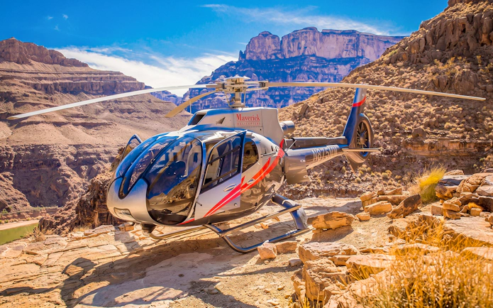 Helicopter landing at Grand Canyon West with canyon views in the background.