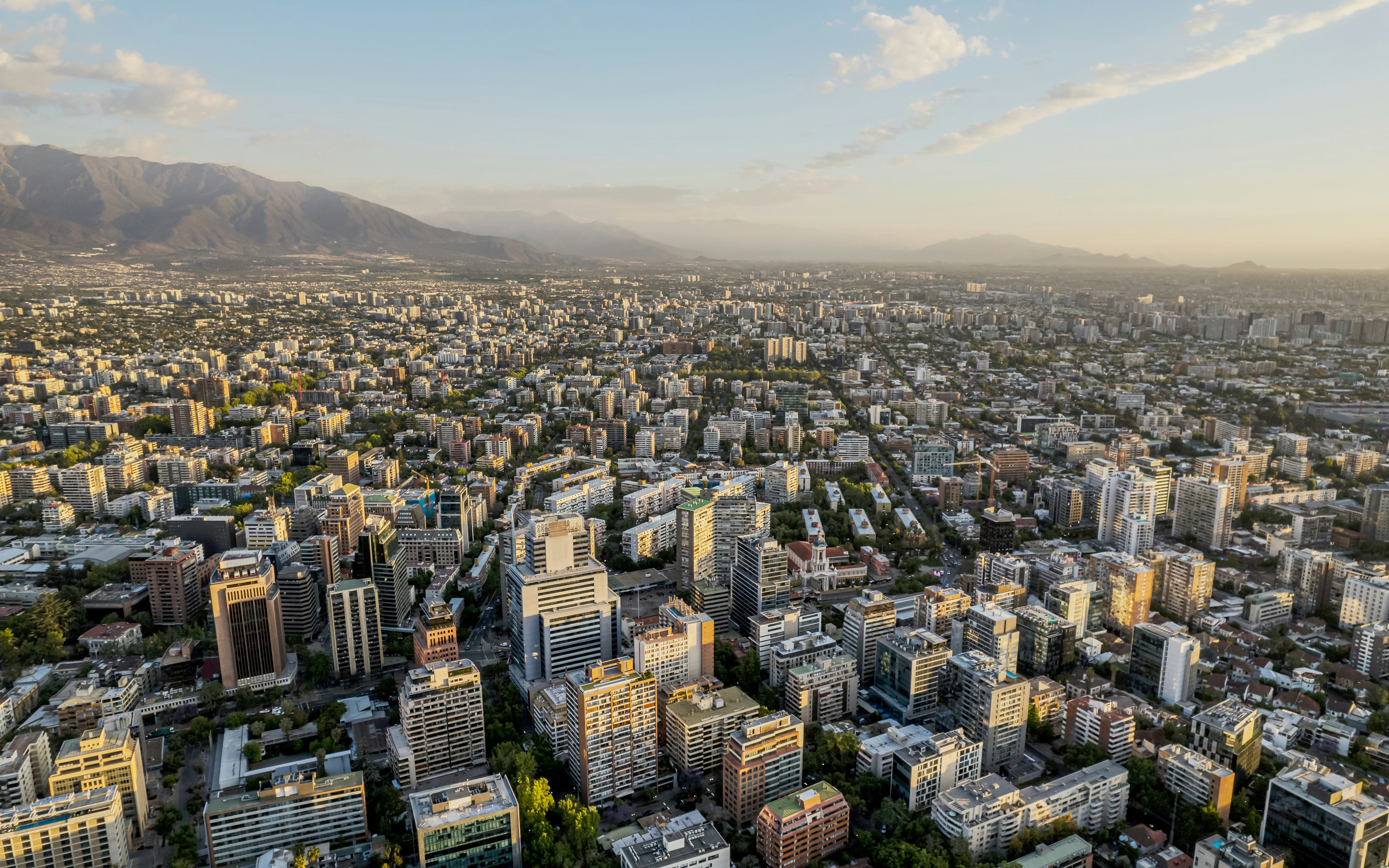 Aerial view of Santiago cityscape from Sky Costanera, showcasing urban landscape and Andes mountains.