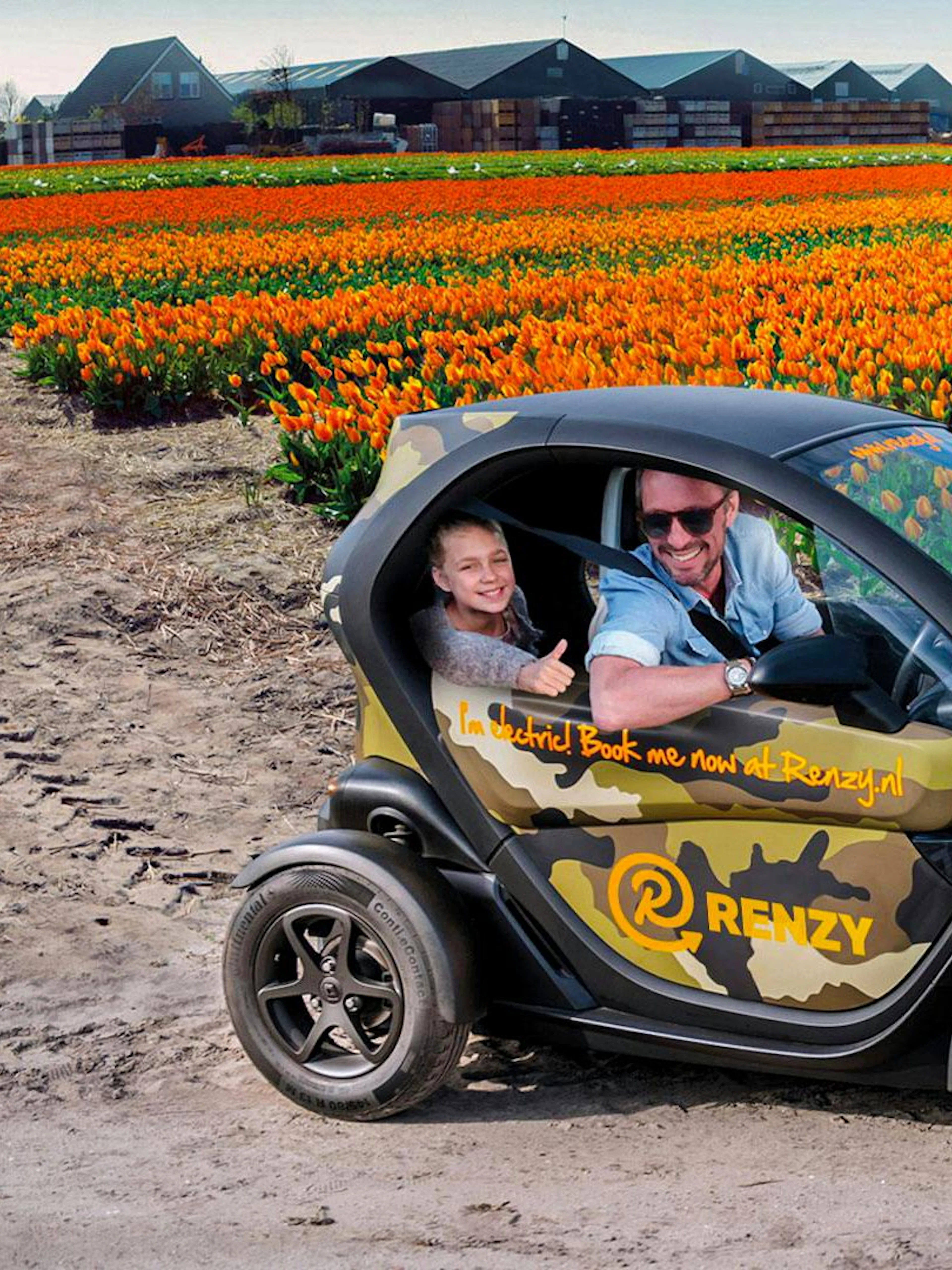 Electric car driving through tulip fields in Keukenhof during self-drive audio tour.