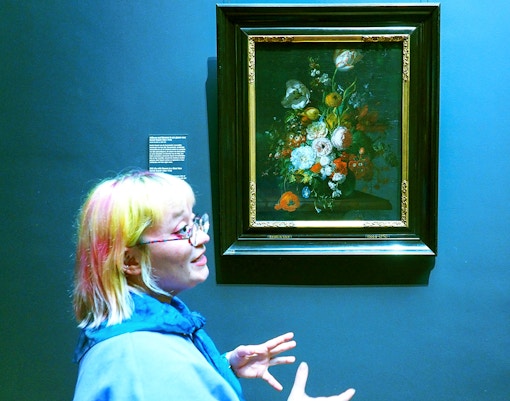 Guide explaining a floral painting at the Rijksmuseum during a private tour.