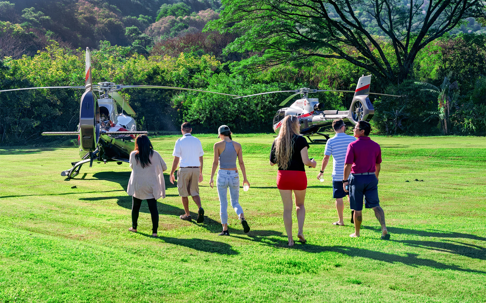 Group approaching helicopter for Hana Rainforest tour in Hawaii.