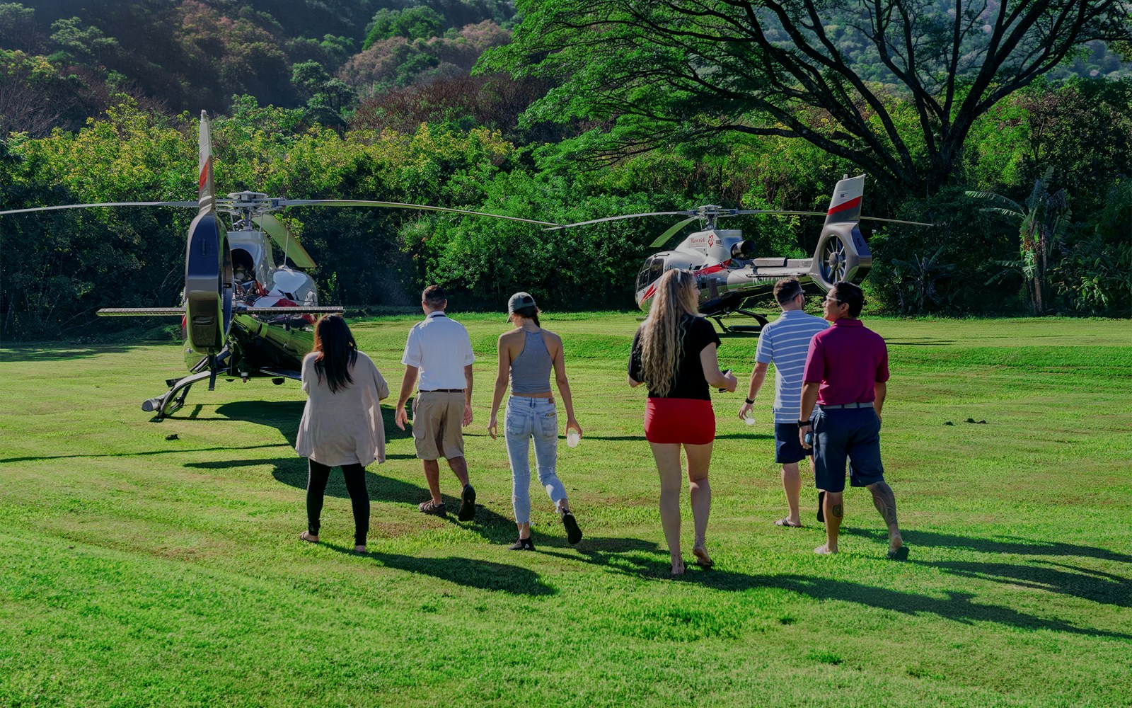 Group approaching helicopter for Hana Rainforest tour in Hawaii.
