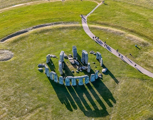 Aerial view of Stonehenge with surrounding green landscape in Wiltshire, England.