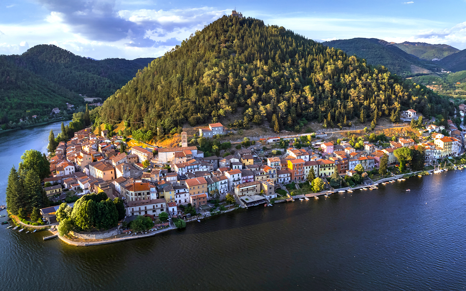 Piediluco Lake with boats and lush hills in the background, Italy.
