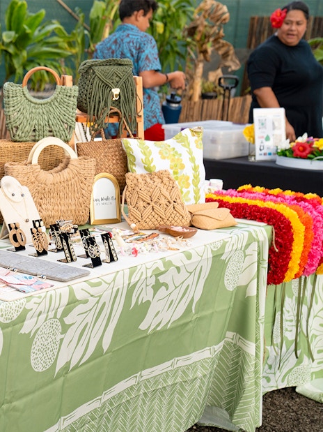 Handcrafted jewelry and bags displayed at Mauka Warriors Luau marketplace.