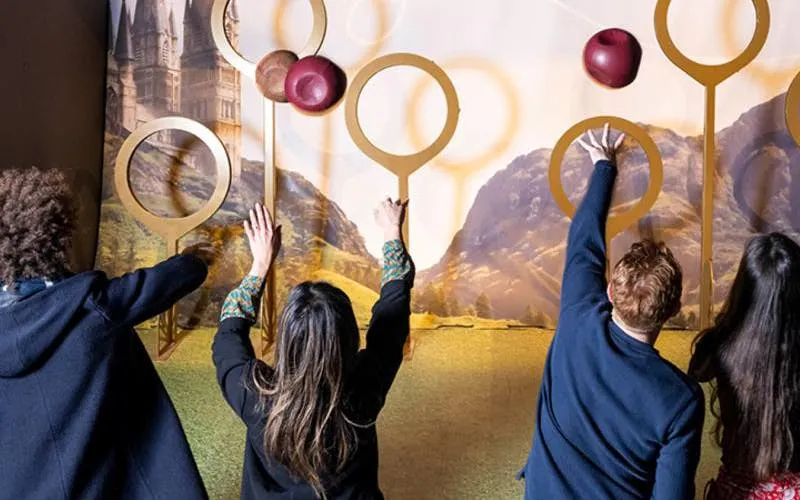 Visitors engaging with Quidditch exhibit at Harry Potter: The Exhibition.