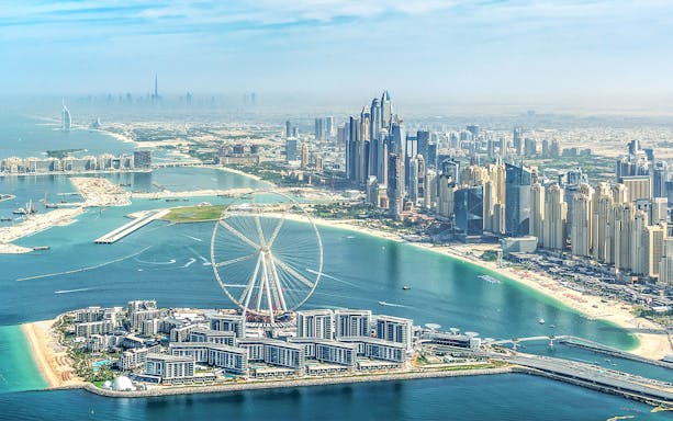 Aerial view of Dubai Marina with Ain Dubai Ferris wheel, near Adventure Zone Watersports.