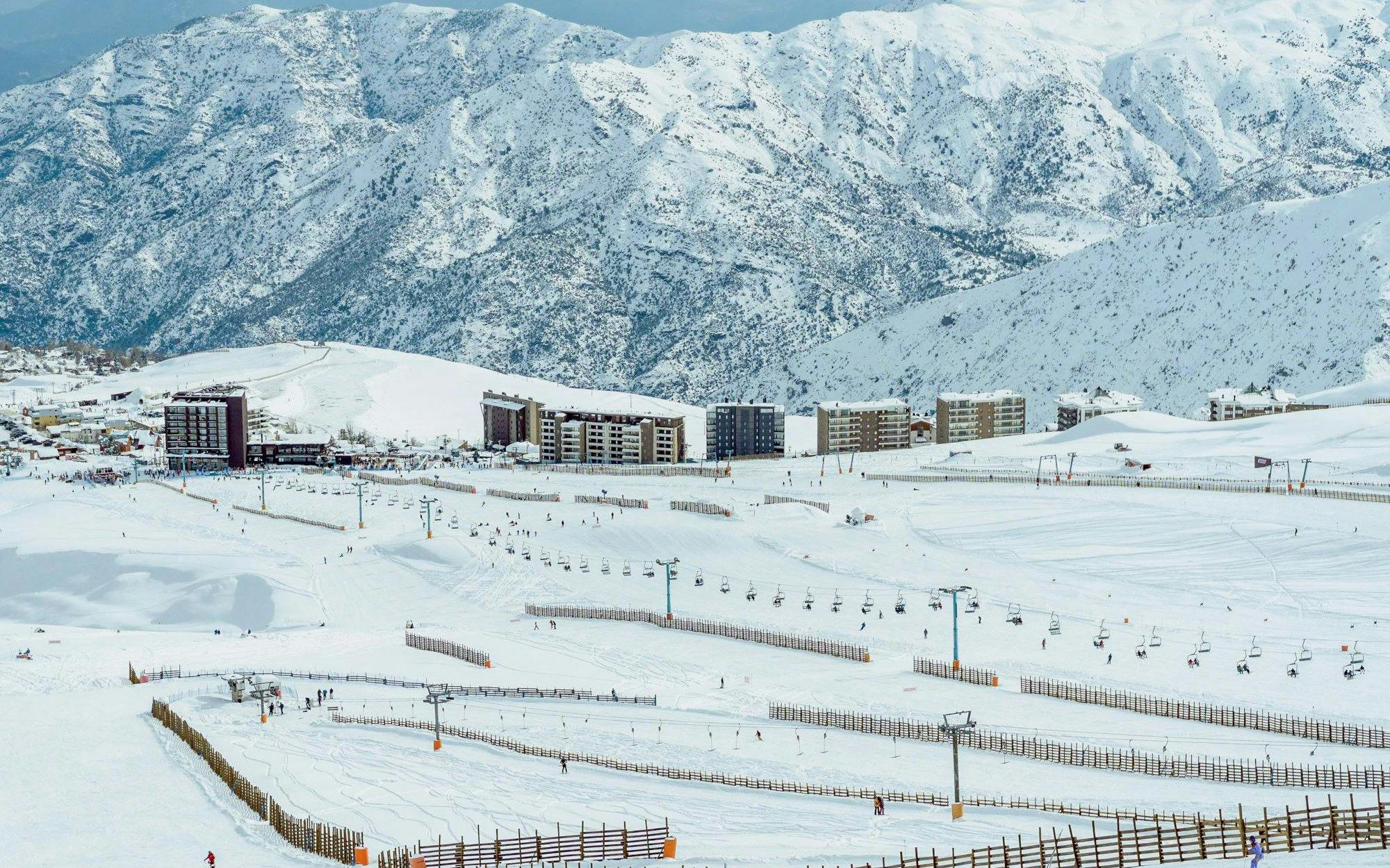Ski slopes and chairlifts at El Colorado Ski Resort, Chile, with snow-covered Andes mountains.