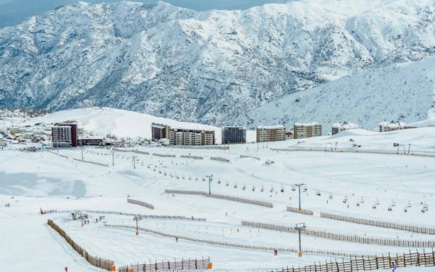 Ski slopes and chairlifts at El Colorado Ski Resort, Chile, with snow-covered Andes mountains.