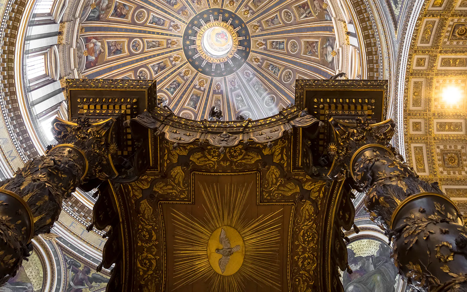 St. Peter’s Basilica Dome interior view with ornate columns and detailed ceiling artwork.