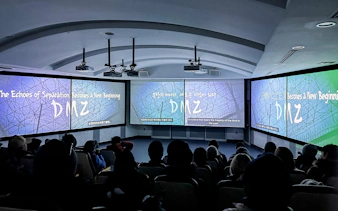 Audience watching a presentation about the DMZ at a theater in South Korea.