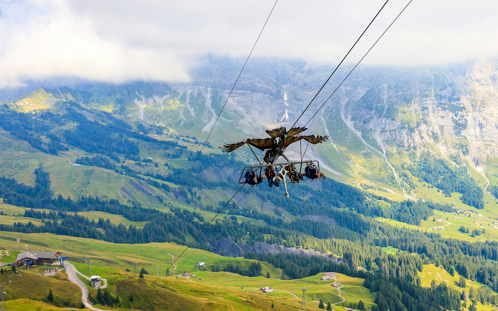 Tourists enjoying the First Glider ride over Grindelwald's scenic landscape, Switzerland.