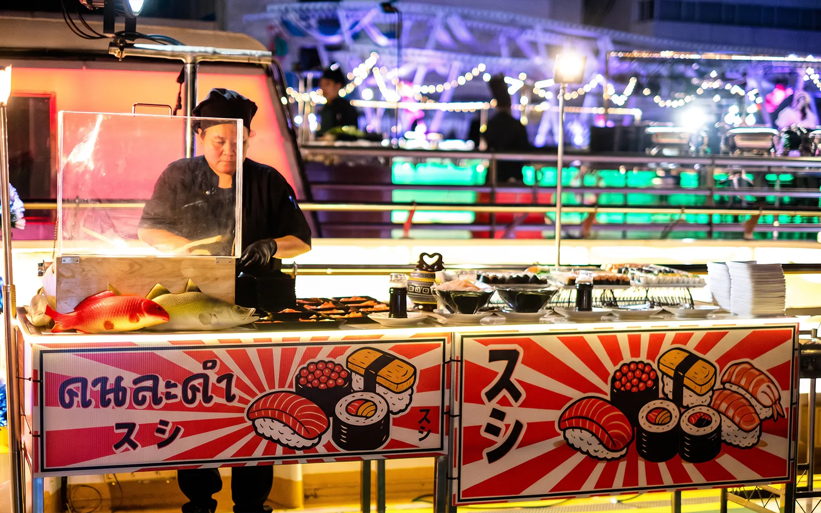 Sushi chef preparing dishes on Riverside Kinlen Cruise in Bangkok.