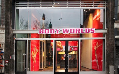 Body Worlds Amsterdam entrance with red interior displays.