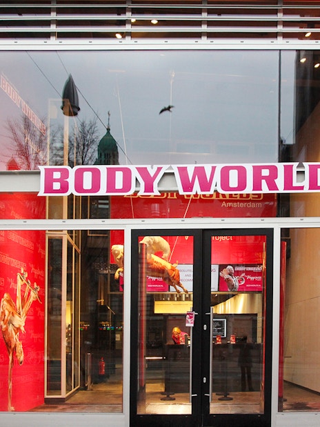 Body Worlds Amsterdam entrance with red interior displays.