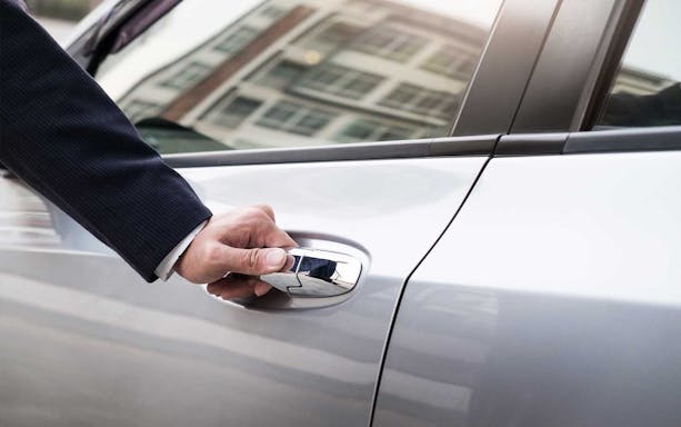 Hand opening car door for shuttle service between Monreale and Palermo.