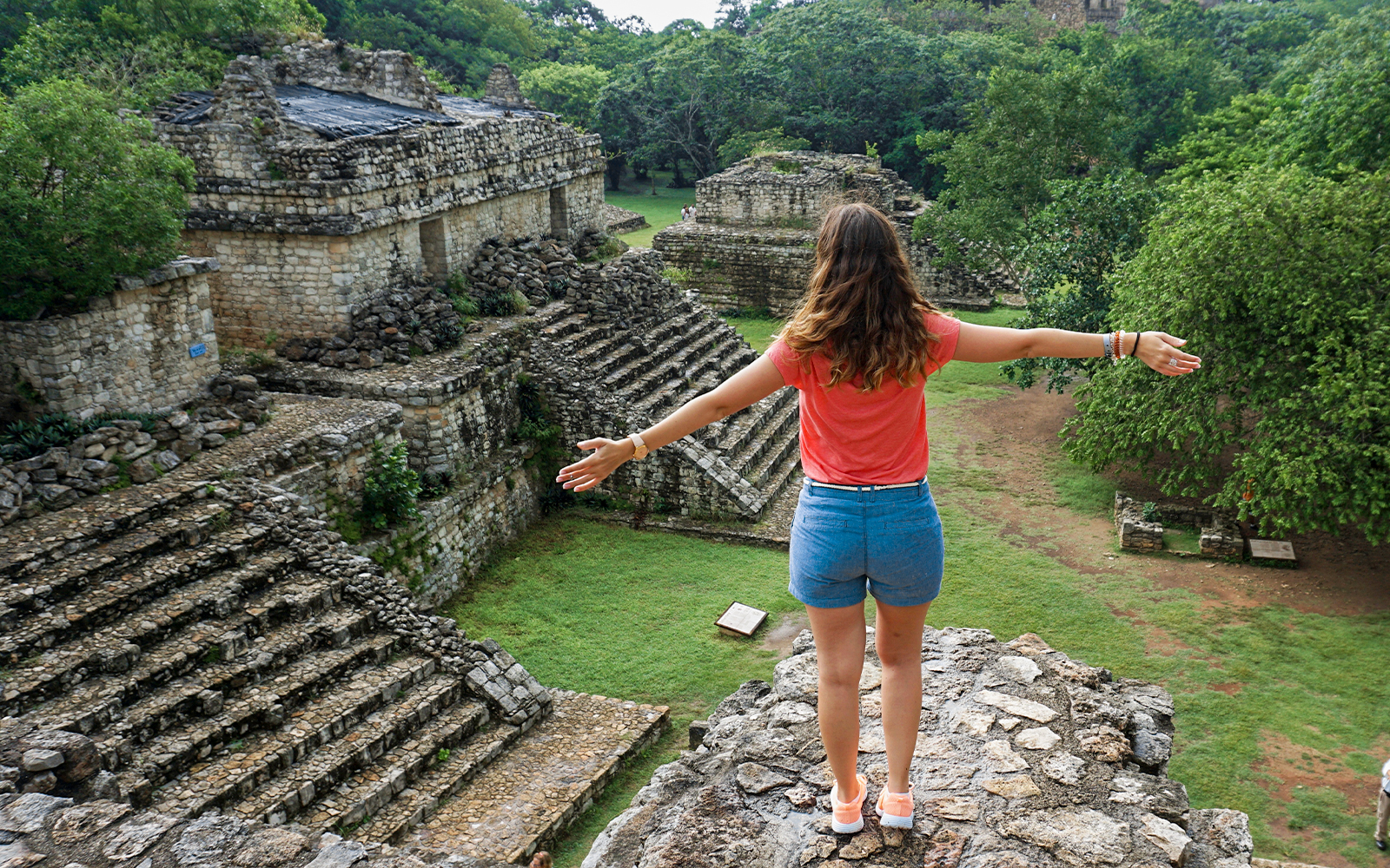 Woman overlooking ancient Mayan ruins in Yaxchilan, Mexico.