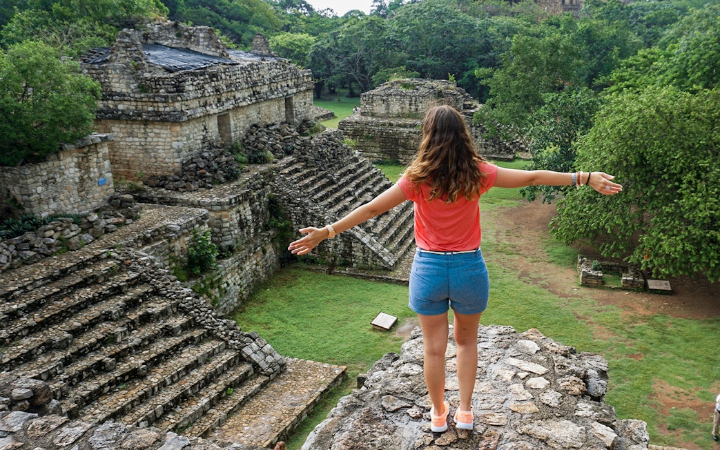 Woman overlooking ancient Mayan ruins in Yaxchilan, Mexico.