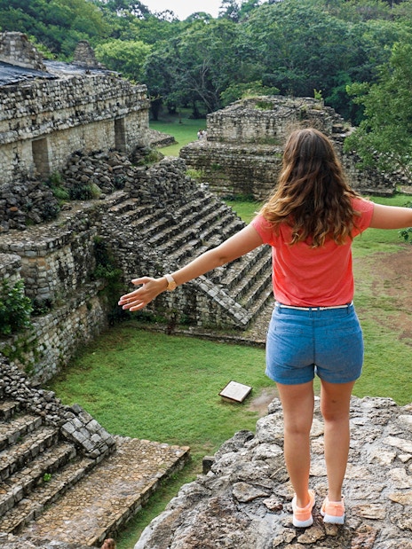 Woman overlooking ancient Mayan ruins in Yaxchilan, Mexico.