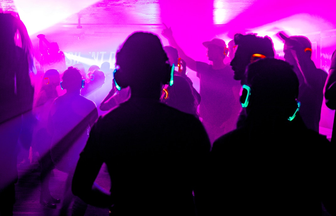 Silent disco with colorful headphones at the Natural History Museum, London.