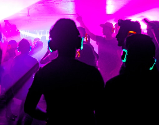 Silent disco with colorful headphones at the Natural History Museum, London.