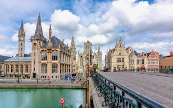 St. Michael's Bridge in Ghent with historic buildings and canal view.