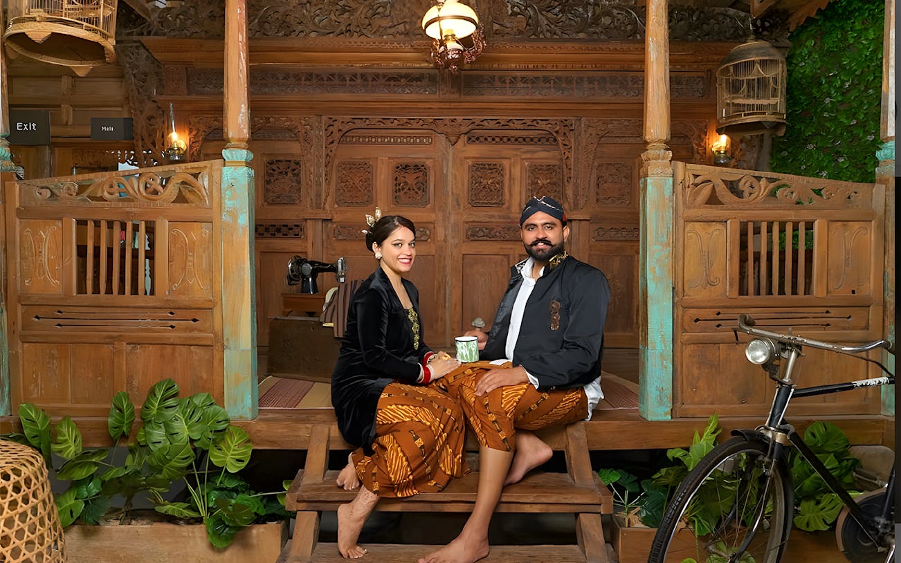 Couple in traditional Balinese attire at Asana Artseum, Garuda Wisnu Kencana, Bali.