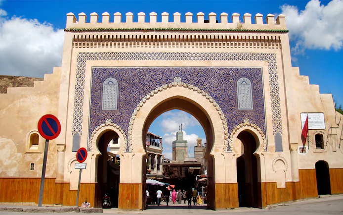 Bab Bou Jeloud gate entrance to Fes Medina, Morocco, with intricate blue tilework.