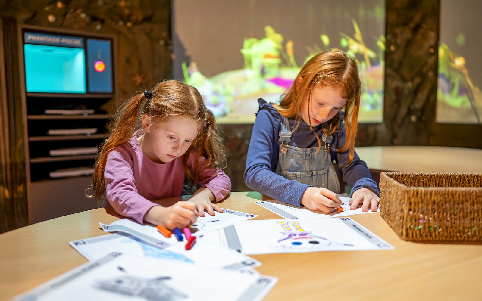 Children coloring at Sea Life Konstanz with marine-themed activity sheets.