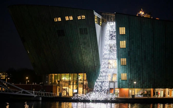 NEMO Science Museum illuminated during Amsterdam Light Festival.