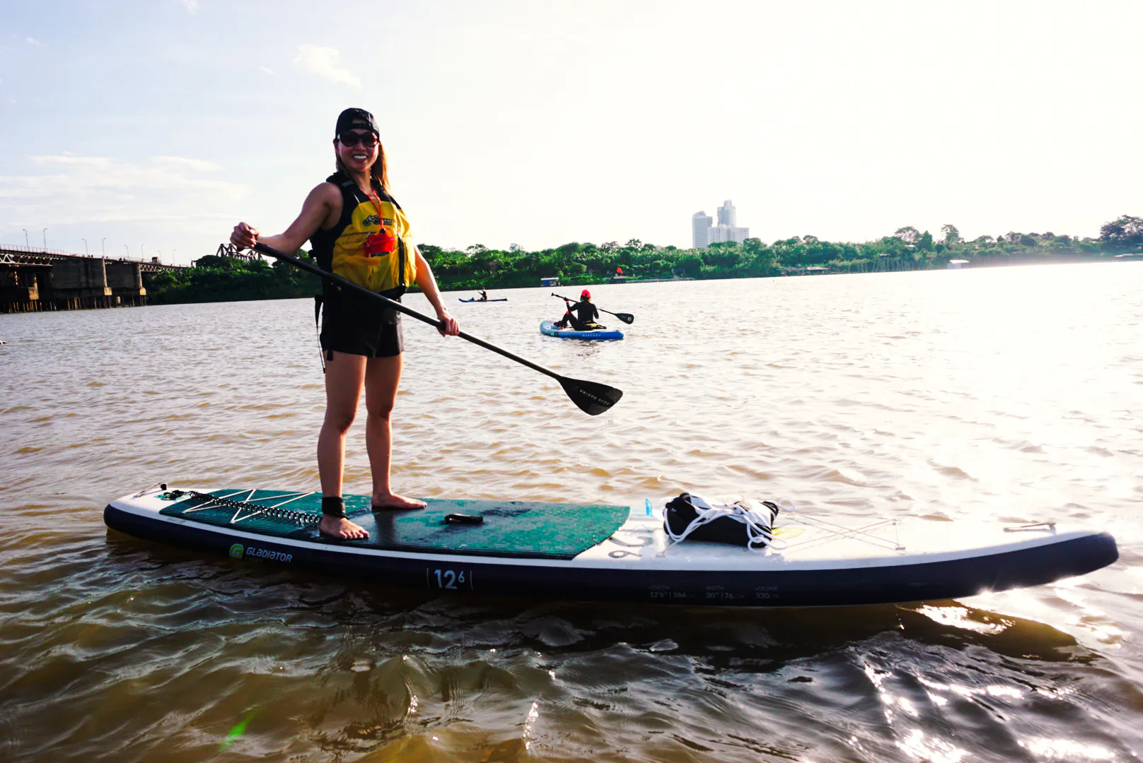 Paddleboarding on the Red River near Nhat Tan Bridge at sunset, Hanoi.