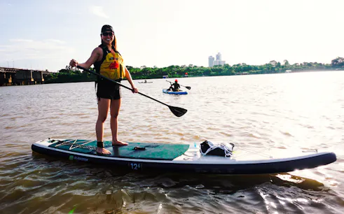 Paddleboarding on the Red River near Nhat Tan Bridge at sunset, Hanoi.