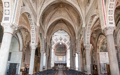 Interior of Santa Maria delle Grazie, Milan, featuring ornate arches and frescoes.