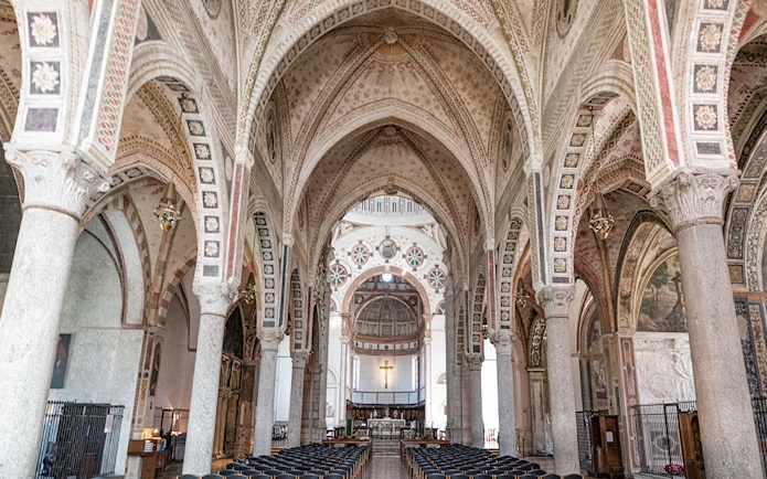 Interior of Santa Maria delle Grazie, Milan, featuring ornate arches and frescoes.