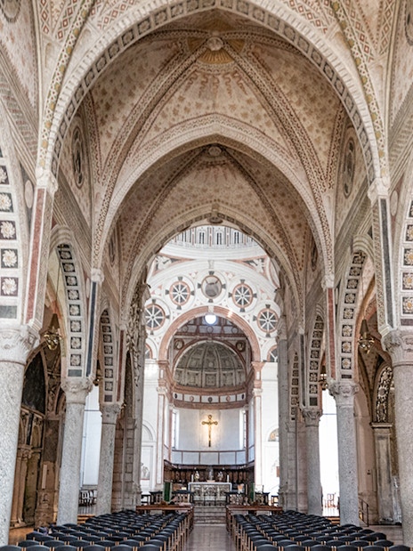 Interior of Santa Maria delle Grazie, Milan, featuring ornate arches and frescoes.