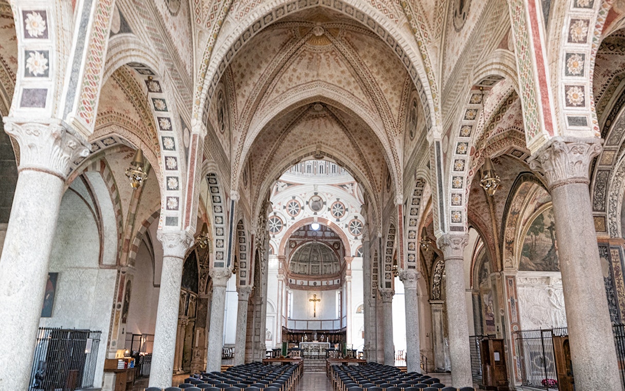 Interior of Santa Maria delle Grazie, Milan, featuring ornate arches and frescoes.