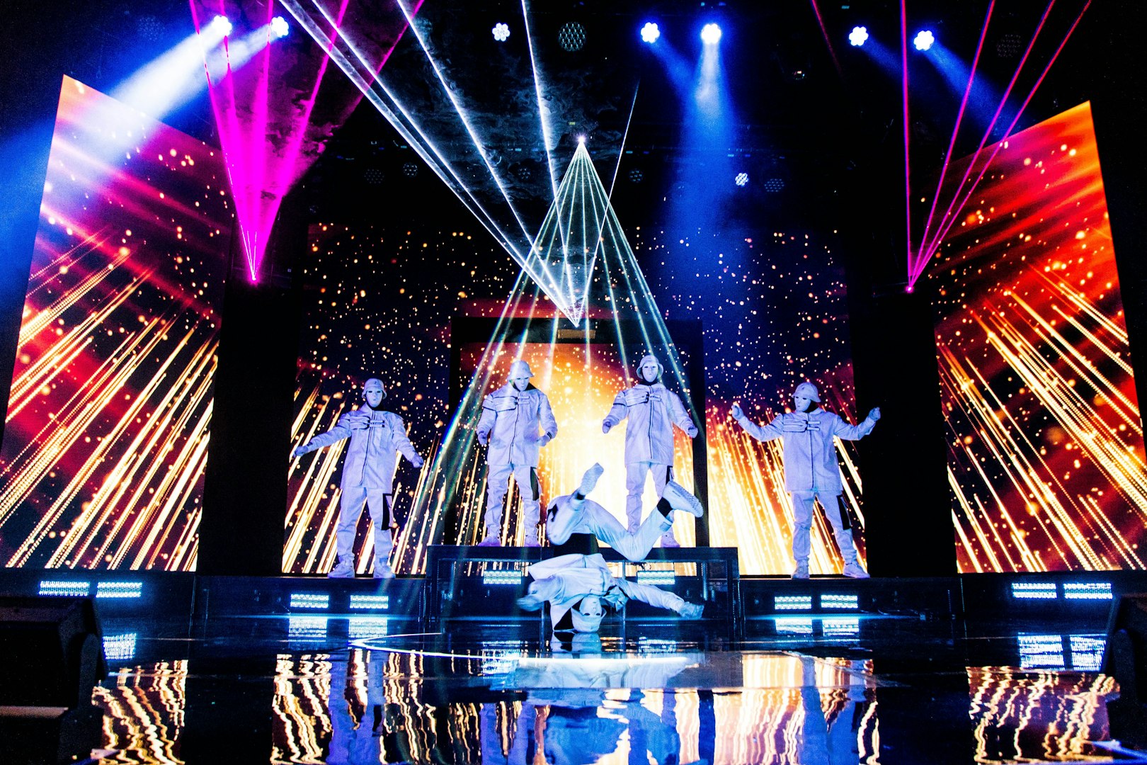 Jabbawockeez dancers performing on stage with vibrant lights in Las Vegas show.