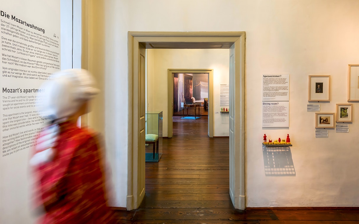 Mozarthaus interior hallway with informational displays and framed pictures.