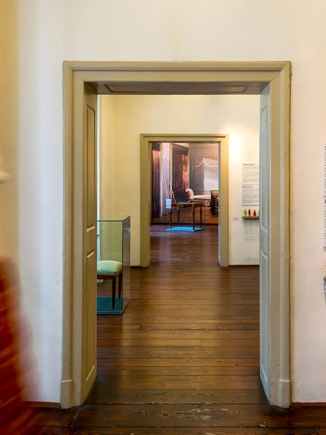 Mozarthaus interior hallway with informational displays and framed pictures.