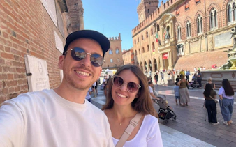 Couple exploring Piazza Maggiore in Bologna during self-guided city game.