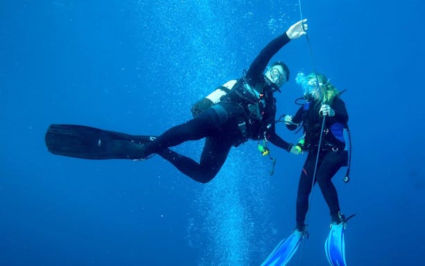 Scuba divers exploring underwater in the Red Sea, Hurghada.