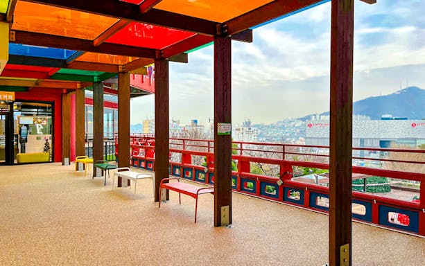 Colorful terrace view from Busan Tower observatory overlooking cityscape.